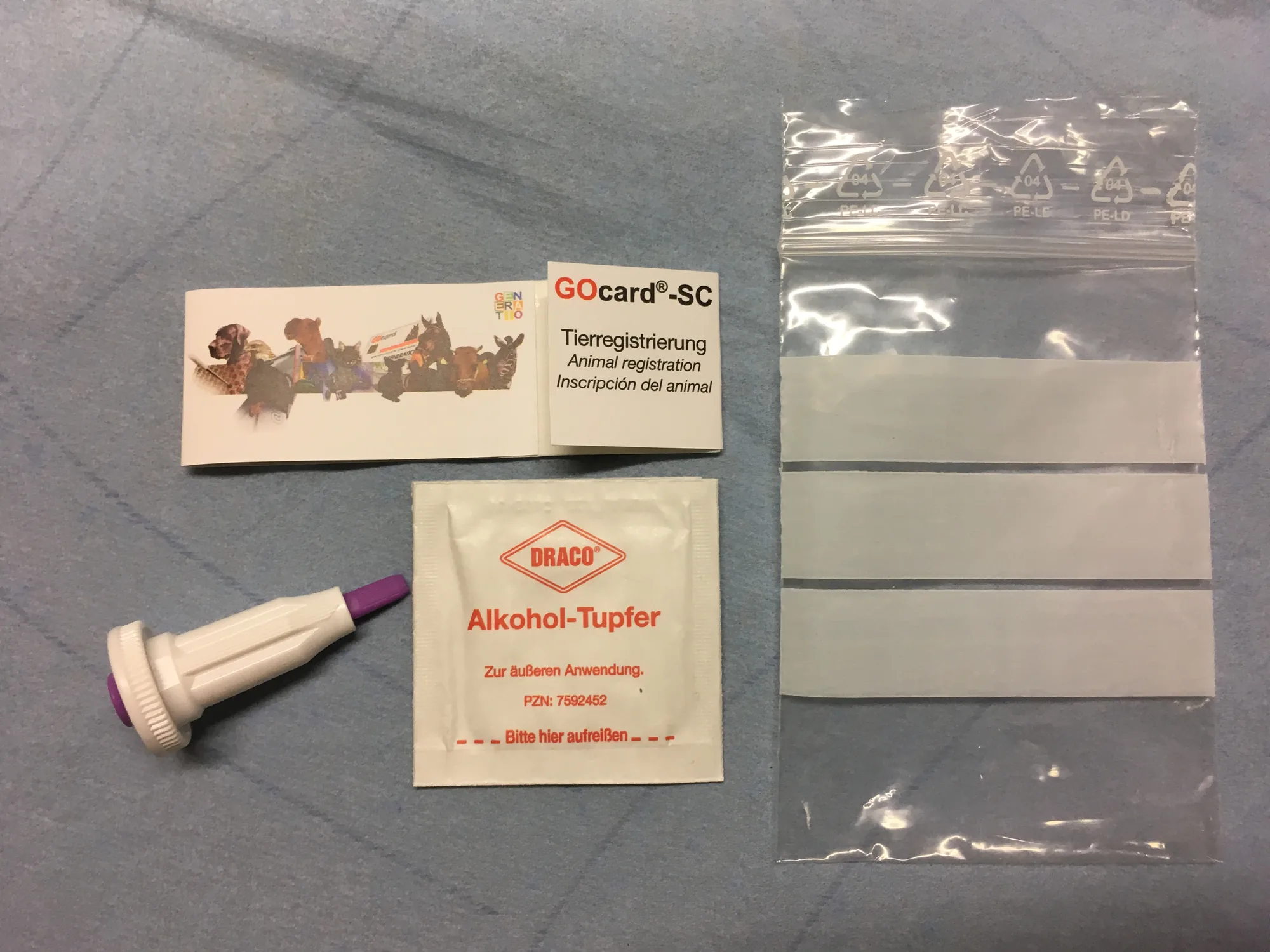 GOcard-SC sampling set GOcard-SC set for animal registration: opened sample card, lancet, alcohol swab and shipping bag.